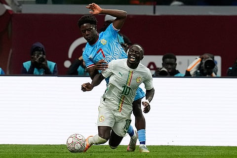 Senegal's Sadio Mane is challenged by DR Congo's Nathanael Mbuku during the Africa Cup of Nations group D soccer match between Senegal and DR Congo in Tangier, Morocco.