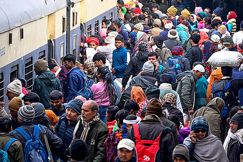 Passengers crowd Patna railway station to board trains amid delays and cancellations caused by dense fog, in Patna.