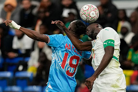 DR Congo's Fiston Mayele and Senegal's Kalidou Koulibaly compete for a header during the Africa Cup of Nations group D soccer match between Senegal and DR Congo in Tangier, Morocco.