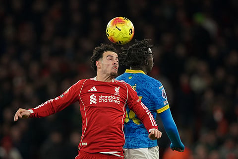 Liverpool's Curtis Jones, front, duels for the ball with Wolverhampton Wanderers' Mateus Mane during the English Premier League soccer match between Liverpool and Wolverhampton Wanderers in Liverpool.