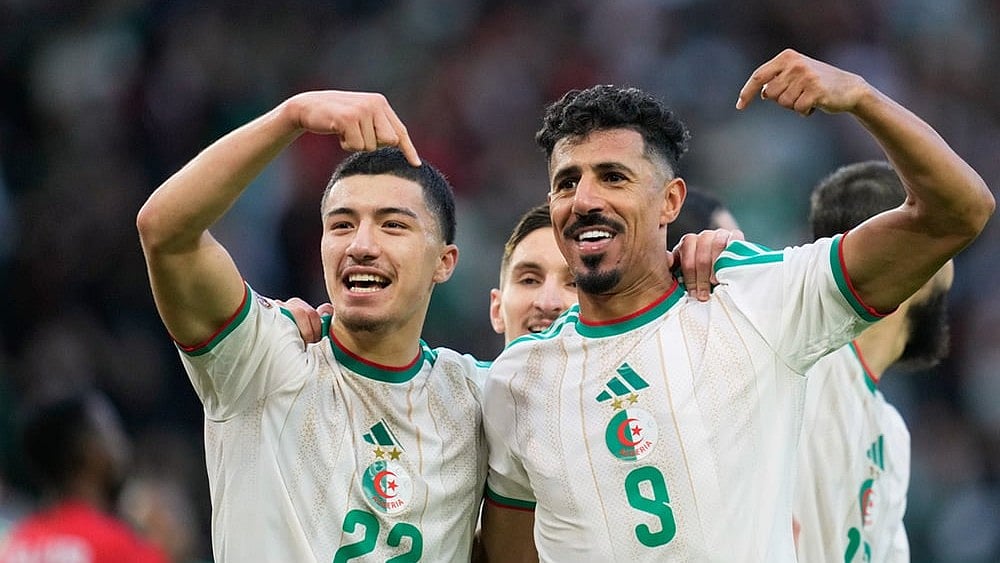 | Photo: AP/Mosa'ab Elshamy : Algeria's Ibrahim Maza, left, celebrates with Algeria's Baghdad Bounedjah after scoring his side's third goal during the Africa Cup of Nations group E soccer match between Algeria and Sudan in Rabat, Morocco.