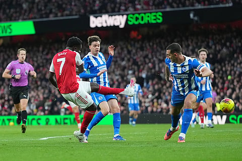 Arsenal's Bukayo Saka has a shot on goal during the English Premier League soccer match between Arsenal and Brighton and Hove Albion in London.