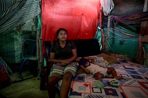 Luciane Mengual, 22, an Indigenous woman from the Wayuu community, poses with her baby at home Feb. 4, 2025, in the Villa del Sur neighborhood, on the outskirts of Riohacha, Colombia.