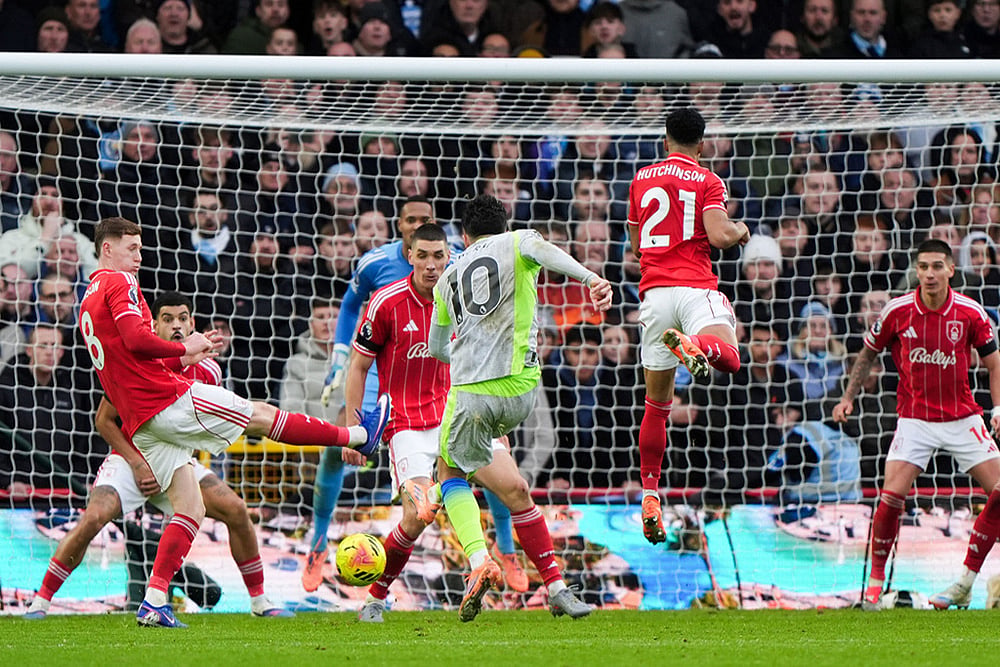 | Photo: Joe Giddens/PA via AP : Manchester City's Rayan Cherki scores his side's second goal during the Premier League match between Nottingham Forest and Manchester City, in Nottingham, England.