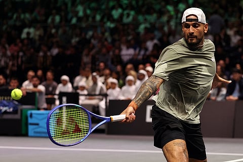 Nick Kyrgios returns the ball to Aryna Sabalenka during their Battle of the Sexes tennis match, in Dubai, United Arab Emirates.