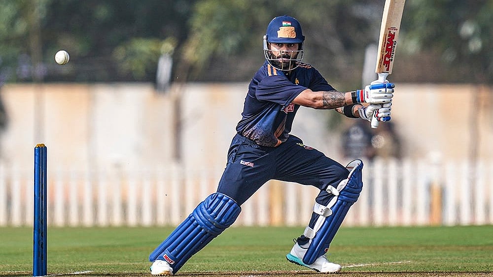 | Photo: PTI/Shailendra Bhojak : Delhi's Virat Kohli plays a shot during the Vijay Hazare Trophy 2025-26 cricket match between Gujarat and Delhi, at BCCI Centre of Excellence Ground, in Bengaluru.