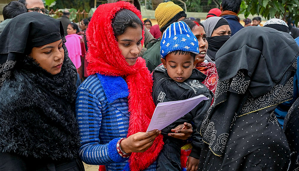 | Photo: PTI : Women wait to enroll for special intensive revision of electoral rolls at Phulia BDO office, in Nadia district, West Bengal.