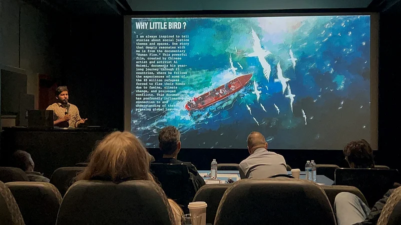 Man presents documentary Human Flow to audience in a theater