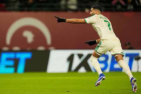 Algeria's Riyad Karim Mahrez celebrates after scoring his side's first goal during the Africa Cup of Nations group E soccer match between Algeria and Burkina Faso in Fez, Morocco.