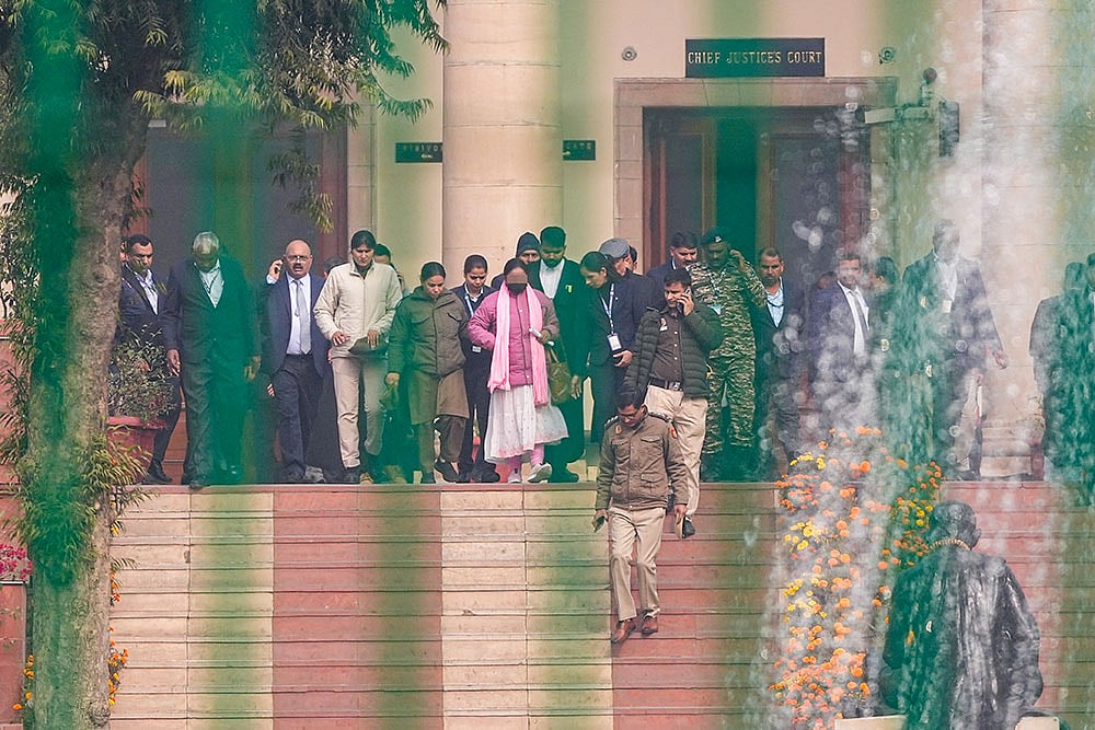 Photo: PTI/Ravi Choudhary : Victim in the Unnao rape case, centre, at Supreme Court in New Delhi. Supreme Court stayed the Delhi High Court's order suspending the life sentence of expelled BJP leader Kuldeep Singh Sengar in the 2017 Unnao rape case.