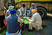 Spiritual And Social Dimensions Of Seva In Sikhism Shutterstock : Haryana, India December 9 2020: Sikh mans sit in a circle to shell peas for langar (community kitchen) preparation during Farmer protest.