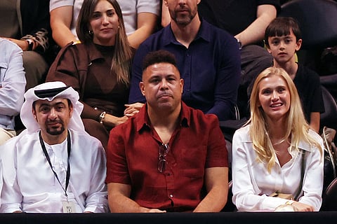 Former footballer Ronaldo, centre, and his partner Celina Locks, right, look on during the Battle of the Sexes tennis match between Aryna Sabalenka and Nick Kyrgios, in Dubai, United Arab Emirates.