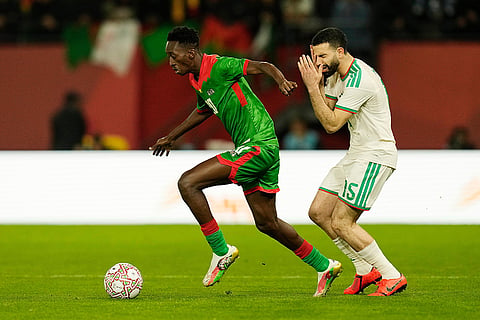 Burkina Faso's Gustavo Sangare, controls the ball away from Algeria's Rayan Ait Nouri during the Africa Cup of Nations group E soccer match between Algeria and Burkina Faso in Rabat, Morocco.
