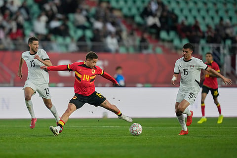 Angola's Manuel Benson controls the ball past Egypt's Mohamed Shehata during the Africa Cup of Nations group B soccer match between Angola and Egypt in Agadir, Morocco.