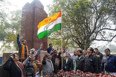Azad Hind People's Mission members hoist a flag during the celebration of 'Shahid Swaraj Diwas', at the INA Memorial, in Kolkata.