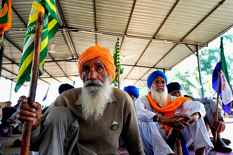 An elderly farmer sits at the daily assembly at Shambhu border