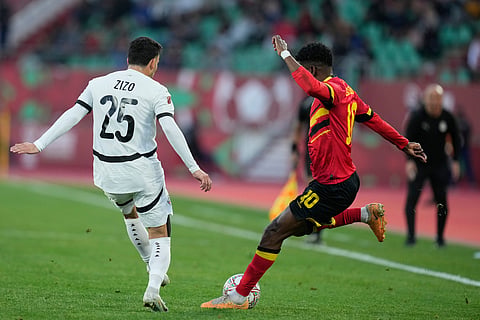 Angola's Gelson Dala, right, kicks the ball during the Africa Cup of Nations group B soccer match between Angola and Egypt in Agadir, Morocco.