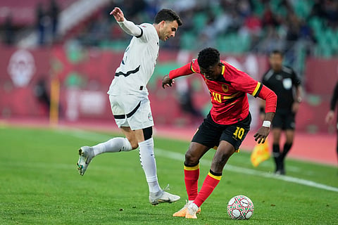 Angola's Gelson Dala, right, controls the ball past Egypt's Ahmed Zizo during the Africa Cup of Nations group B soccer match between Angola and Egypt in Agadir, Morocco.