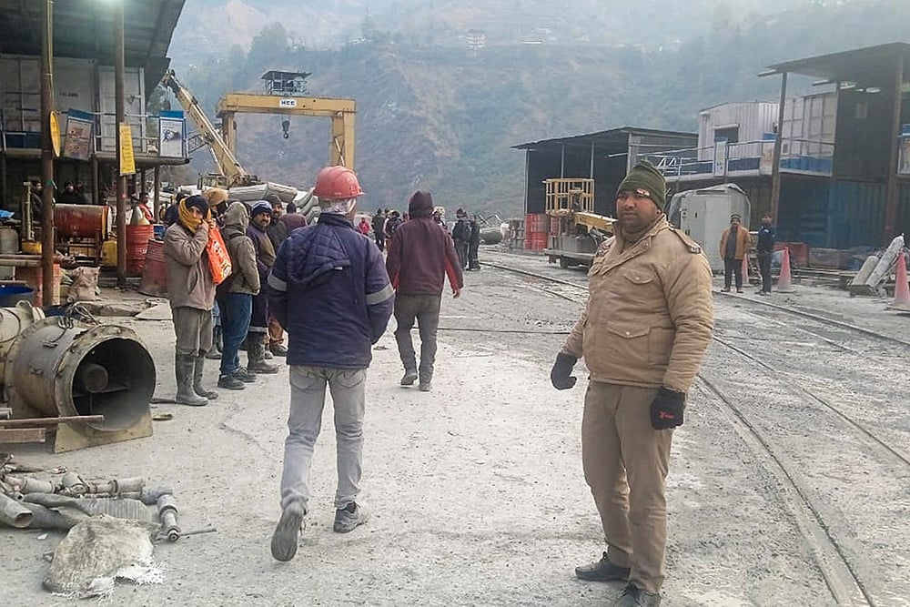 | Photo: PTI : Security personnel at the site after a loco train collided with a goods train on Tuesday night inside Pipalkoti tunnel of the Vishnugad-Pipalkoti Hydro Electric Project tunnel in Gopeshwar area, Chamoli district. Atleast 60 people were injured in the incident. 
