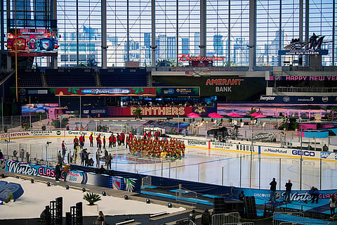 The Florida Panthers team pose for a picture during practice for the NHL Winter Classic outdoor hockey game at loanDepot Park in Miami.