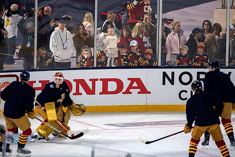 Children watch the Florida Panthers work out during practice for the NHL Winter Classic outdoor hockey game at loanDepot Park in Miami.