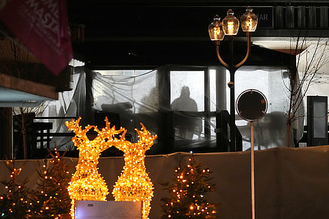 Shadows of People are seen in the sealed off Le Constellation bar, where a devastating fire left dead and injured during the New Year's celebrations in Crans-Montana, Swiss Alps, Switzerland.