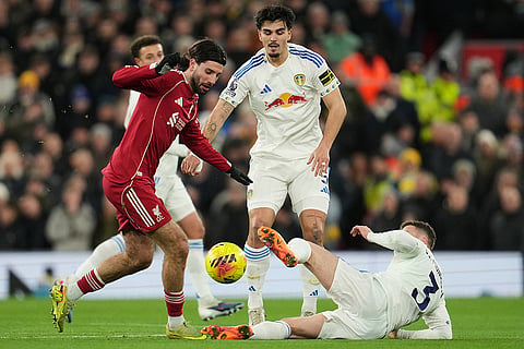 Liverpool's Dominik Szoboszlai, left, and Leeds' Gabriel Gudmundsson challenge for the ball during the English Premier League soccer match between Liverpool and Leeds United in Liverpool, England.
