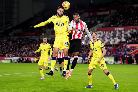 Tottenham Hotspur's Rodrigo Bentancur, left, and Brentford's Rico Henry in action during the English Premier League soccer match between Brentford and Tottenham Hotspur in London.
