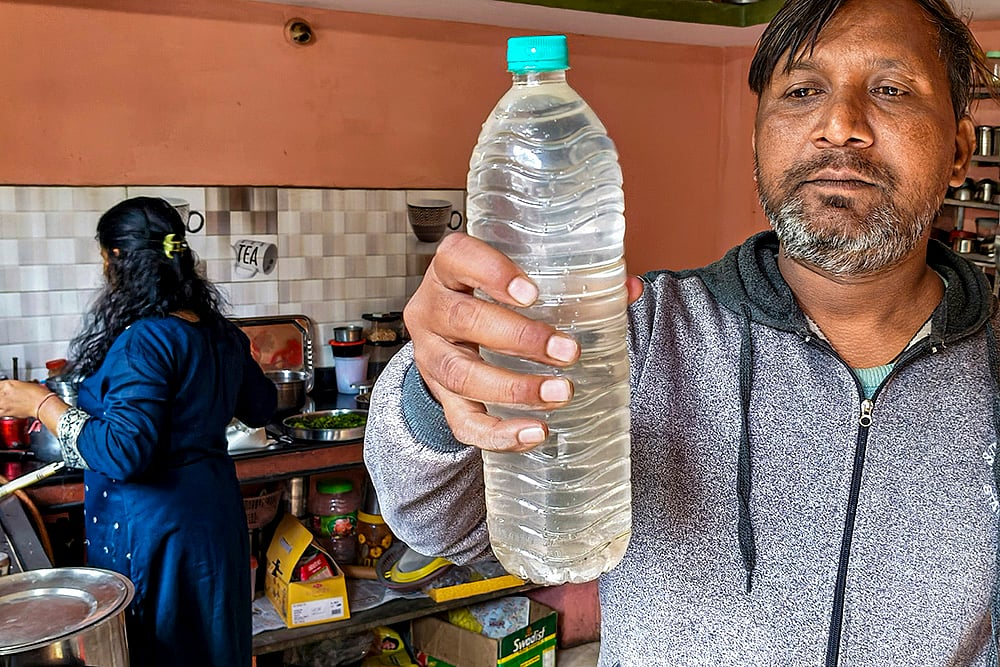 | Photo: PTI : A person shows a sample of the drinking water that is being collected following a diarrhoea outbreak caused by contaminated water, at Bhagirathpura area, in Indore, Madhya Pradesh.