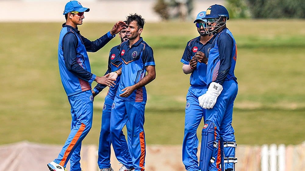 | Photo: PTI/Shailendra Bhojak : Gujarat's Ravi Bishnoi, centre, with teammates celebrates after taking the wicket of Delhi's Ayush Badoni during the Vijay Hazare Trophy 2025-26 cricket match between Gujarat and Delhi, at BCCI Centre of Excellence Ground, in Bengaluru.