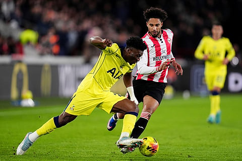 Tottenham Hotspur's Mohammed Kudus, left, and Brentford's Kevin Schade in action during the English Premier League soccer match between Brentford and Tottenham Hotspur in London.