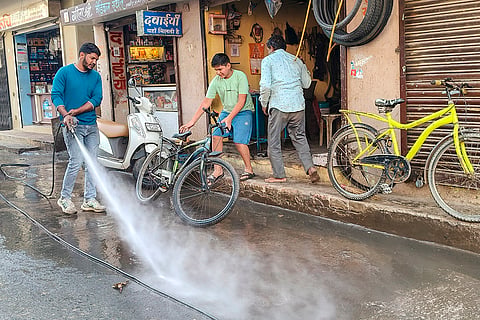 An Indore Municipal Corporation worker during a cleanliness drive after several people were affected due to consumption of contaminated water at Bhagirathpura area, in Indore, Madhya Pradesh.
