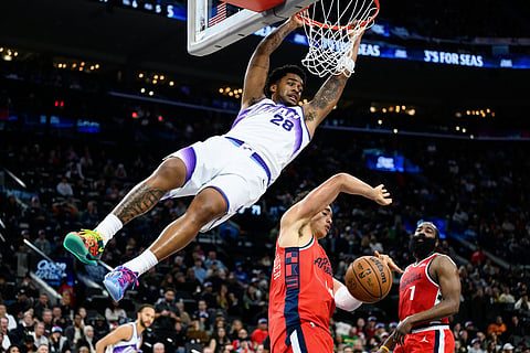 Utah Jazz forward Brice Sensabaugh (28) dunks over Los Angeles Clippers center Yanic Konan Niederhauser, center, during the second half of an NBA basketball game in Inglewood, California.