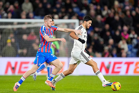 Crystal Palace's Adam Wharton, left, and Fulham's Raul Jimenez battle for the ball during their English Premier League soccer match in London.