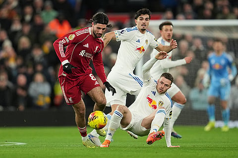 Liverpool's Dominik Szoboszlai, left, and Leeds' Gabriel Gudmundsson challenge for the ball during the English Premier League soccer match between Liverpool and Leeds United in Liverpool, England.