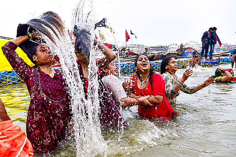 People take a holy dip at the Sangam on the occasion of 'Paush Purnima', marking the start of the 'Magh Mela' festival, on a cold winter morning, in Prayagraj.