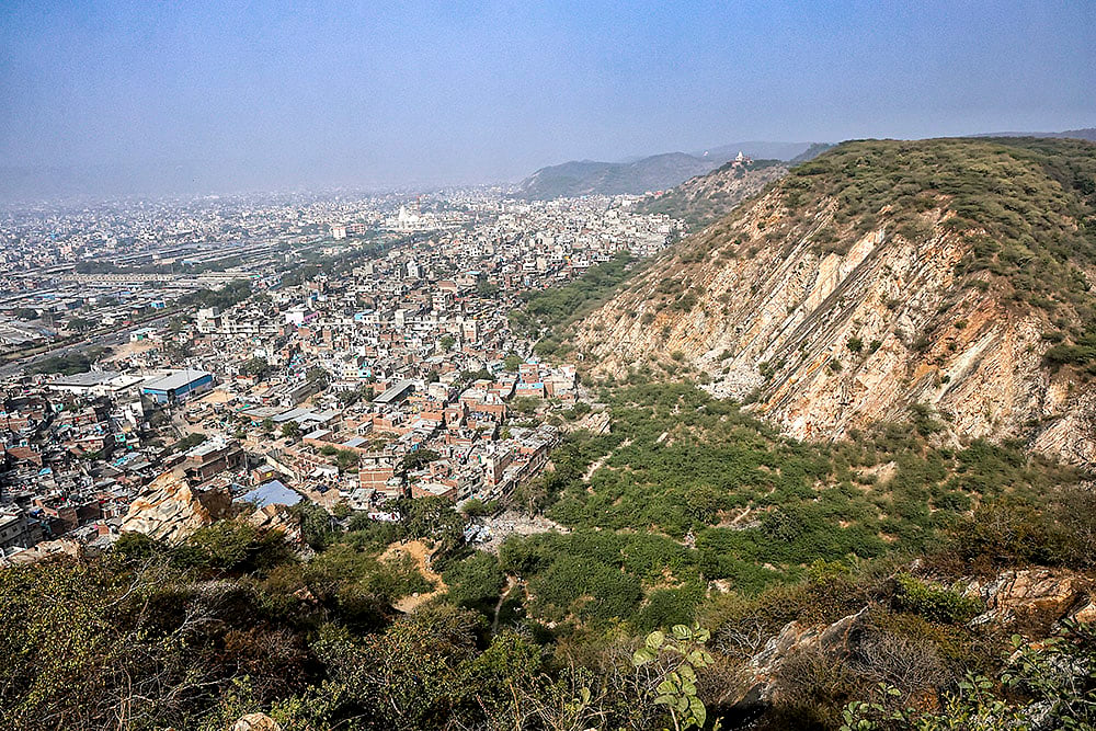 | Photo: PTI : The Aravalli Hills, as seen from the Sun temple at Galta ji, in Jaipur, Saturday, Jan. 3, 2026. The Supreme Court on Monday kept in abeyance its Nov. 20 directions that accepted a uniform definition of the Aravalli hills and ranges. It also directed that until further orders, no permission shall be granted for mining in the 'Aravalli Hills and Ranges', as defined in the Aug. 25, 2010, FSI report, without its prior permission. 