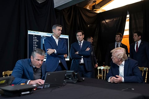 In this photo released by the White House, President Donald Trump talks with CIA Director John Ratcliffe and Secretary of State Marco Rubio as Defense Secretary Pete Hegseth looks at a computer screen as he monitors U.S. military operations in Venezuela, at Mar-a-Lago in Palm Beach, Fla.