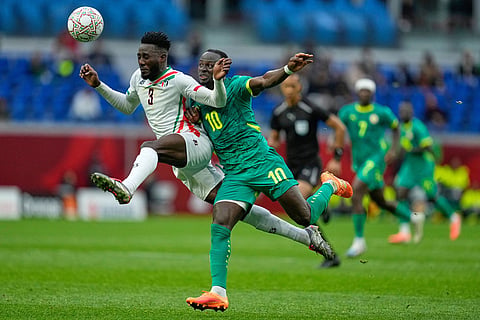 Sudan's Mohamedahmed Saeed Ahmed, left, and Senegal's Sadio Mane fight for the ball during the Africa Cup of Nations best of 16 soccer match between Senegal and Sudan in Tangier, Morocco.