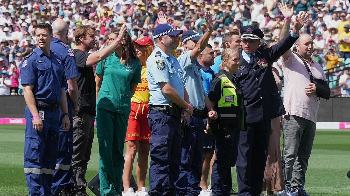 | Photo: AP/Mark Baker : First responders and survivors from the Bondi Beach shooting wave from the field during a ceremony ahead play on day one of the fifth and final Ashes cricket test between England and Australia in Sydney, Sunday, Jan. 4, 2026. 
