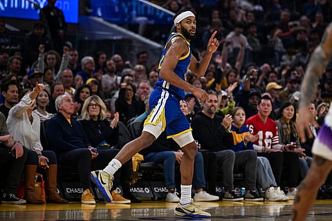Golden State Warriors guard Moses Moody reacts after a 3-point basket during the first half of an NBA basketball game against the Utah Jazz in San Francisco.