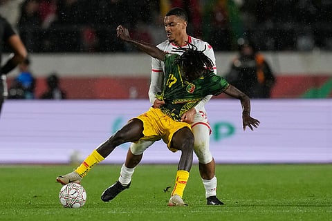 Tunisia's Yan Valery holds Mali's Gaoussou Diakite during the Africa Cup of Nations best of 16 soccer match between Mali and Tunisia in Casablanca, Morocco.