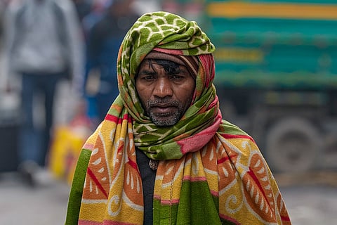 A man wearing a blanket walks by on a cold winter morning, at Kashmere Gate area, in New Delhi, Sunday, Jan. 4, 2026. () ()