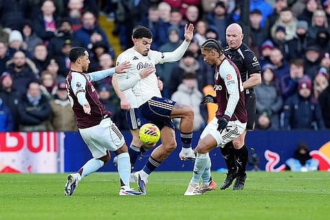 Aston Villa's Youri Tielemans, left, and Boubacar Kamara battle for the ball with Nottingham Forest's Morgan Gibbs-White, center, during their English Premier League soccer match in Birmingham, England.