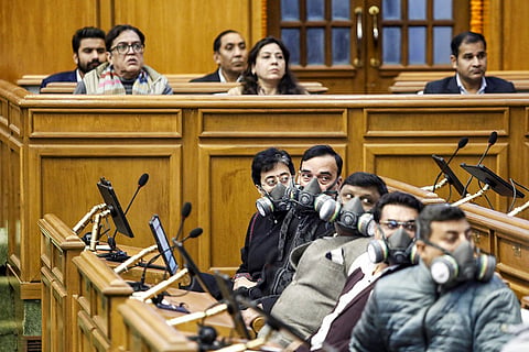 Leader of Opposition in the Delhi Legislative Assembly Atishi, with AAP leaders, wears a mask during the Winter session of the Assembly, in New Delhi.