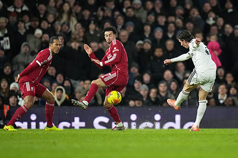 Fulham's Harry Wilson takes a shot at goal during the English Premier League soccer match between Fulham and Liverpool in London.
