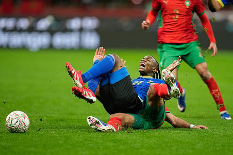 Tanzania's Alphonce Mabula Msanga falls on Morocco's Ismael Saibari as they fight for the ball during the Africa Cup of Nations round of 16 soccer match between Morocco and Tanzania in Rabat, Morocco.