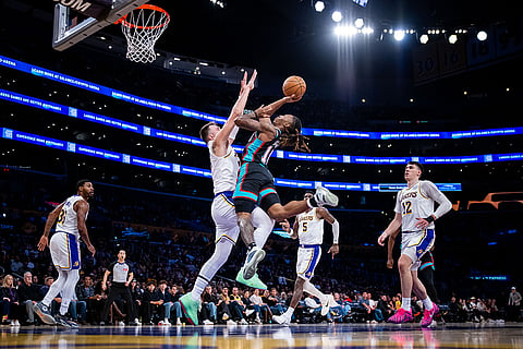 Memphis Grizzlies guard Javon Small (10) is defended by Los Angeles Lakers guard Luka Doncic (77) during the first half of an NBA basketball game, in Los Angeles. 