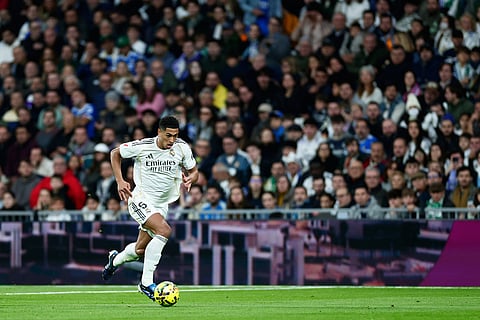 Real Madrid's Jude Bellingham controls the ball during the Spanish La Liga soccer match between Real Madrid and Real Betis Sevilla in Madrid, Spain.