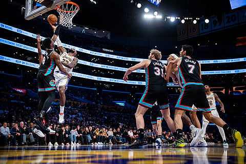 Los Angeles Lakers forward LeBron James (23) drives to the basket against Memphis Grizzlies forward Jaren Jackson Jr. (8) during the second half of an NBA basketball game in Los Angeles. 
